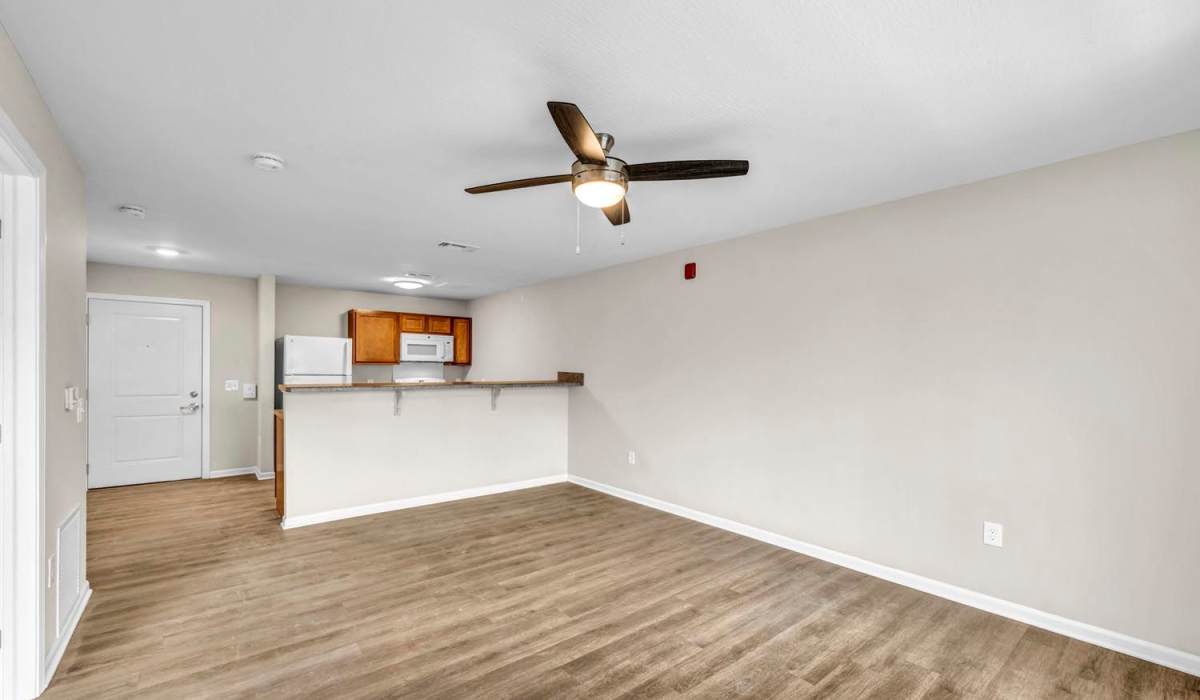 Living area with ceiling fan and kitchen bar at Chesterfield Terrace in Parma, Ohio