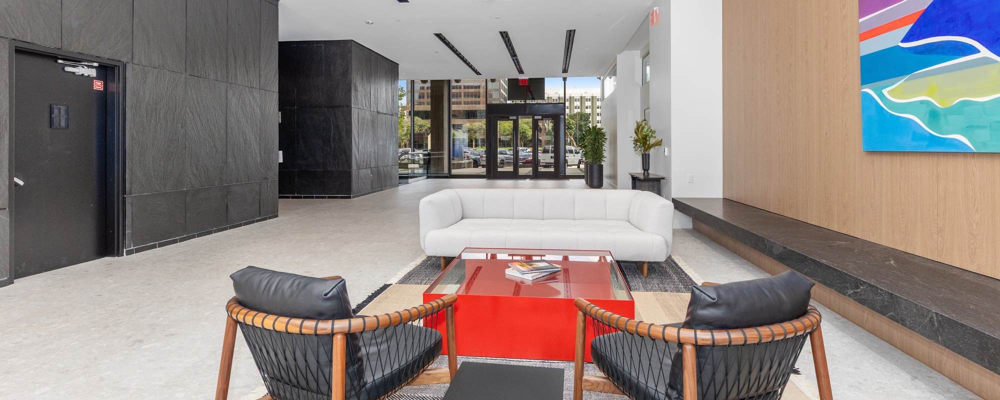 Indoor golf simulator lounge with seating and practice area at Residences at 111 Lyon in Grand Rapids, Michigan