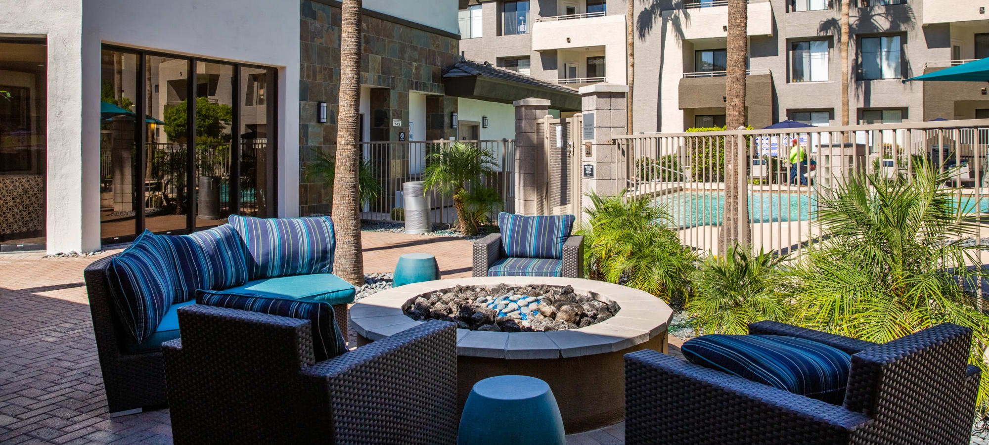 Luxurious pool side patio with chairs and firepit at Ascent at Papago Park, Phoenix, Arizona