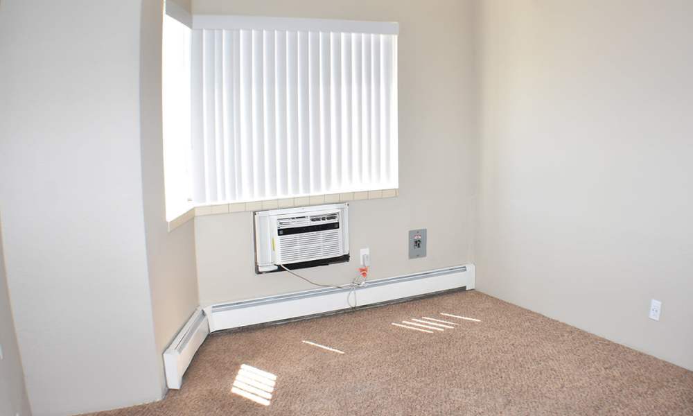 Bedroom with large window in a model apartment at Truckee River Terrace in Reno, Nevada