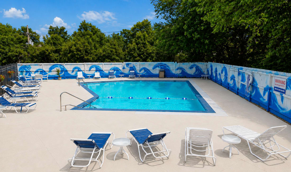 Community pool with lounge chairs at Union Flats & Townhomes in Lawrence, Kansas