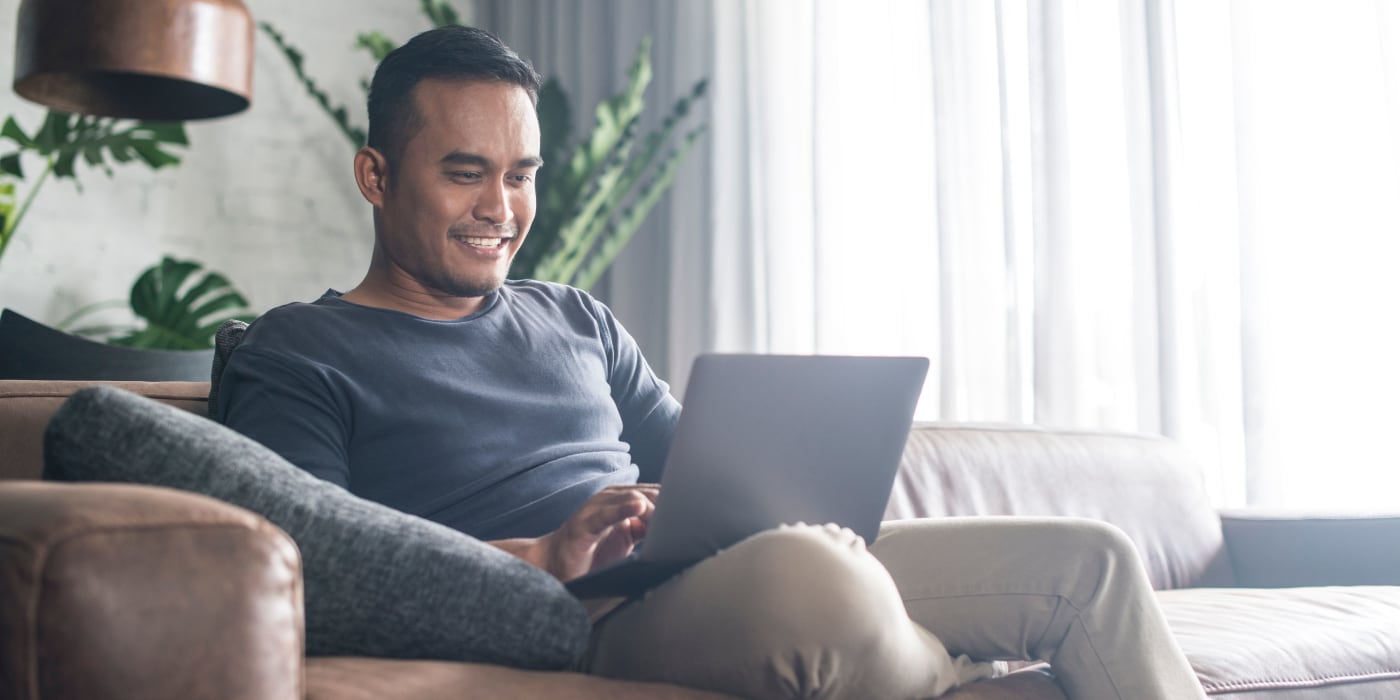 A student on his computer in his apartment at Vue at Laurel Canyon in Valley Village, California