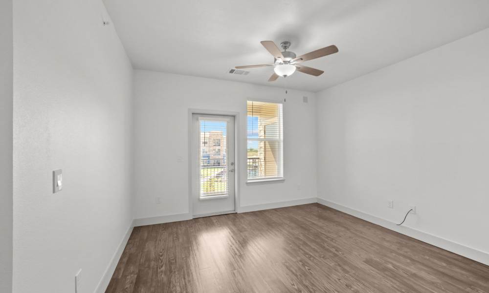Living room with wood-style flooring at Brook Hollow in Wichita Falls, Texas