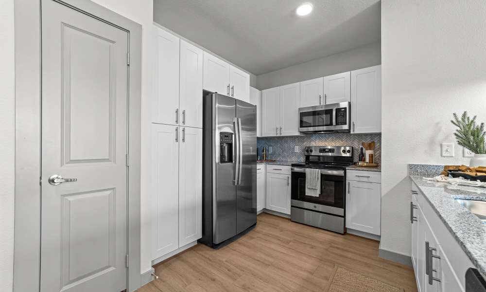 Kitchen with white cabinetry at Main and Mill in Lewisville,Texas