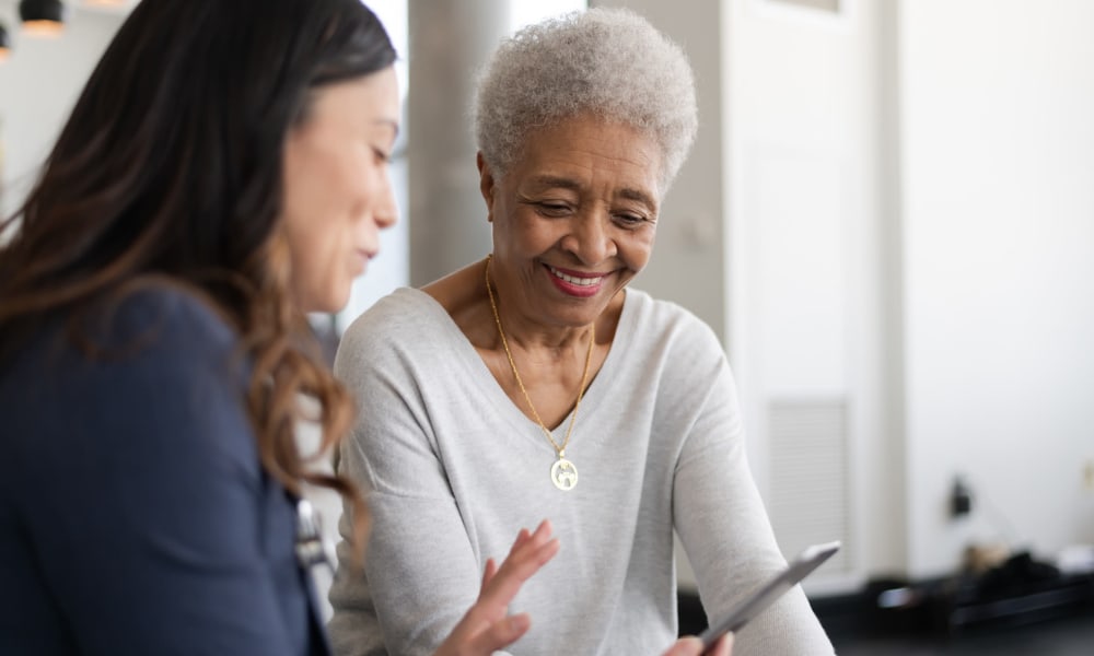 Resident discussing health info with a caretaker at a Jaybird Senior Living community