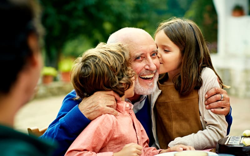 Happy grandfather with kids at Grand Villa of Delray Beach East in Delray Beach, Florida