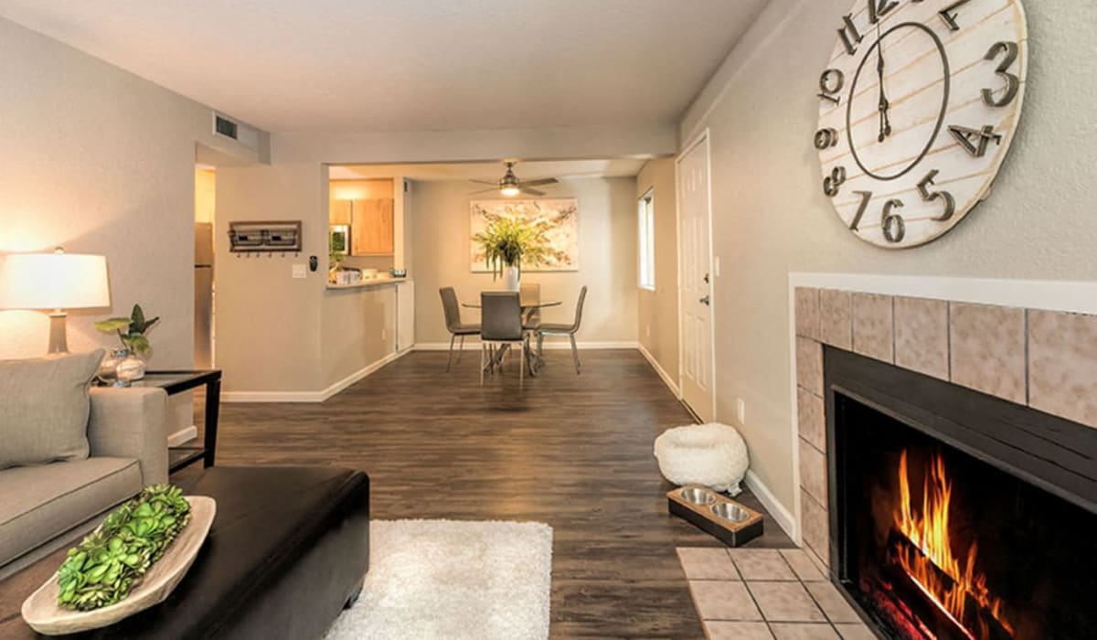 Open concept living room with wood-style floors at The Reva in Citrus Heights, California