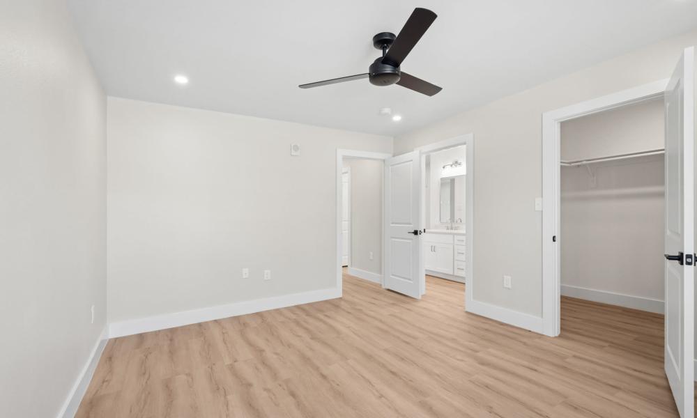 Bedroom with a ceiling fan and a wooden flooring at Lake Meadows in Garland, Texas