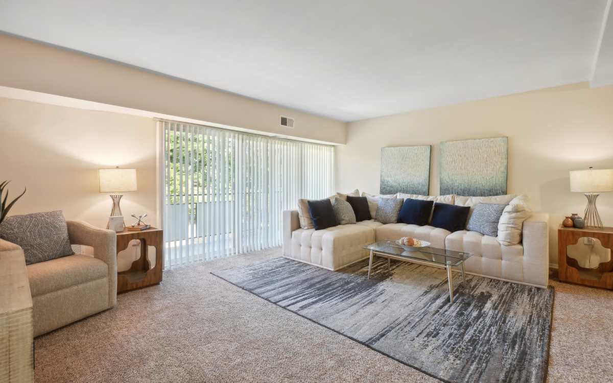 Living room extending to the private balcony at Fox Club in Capitol Heights, Maryland