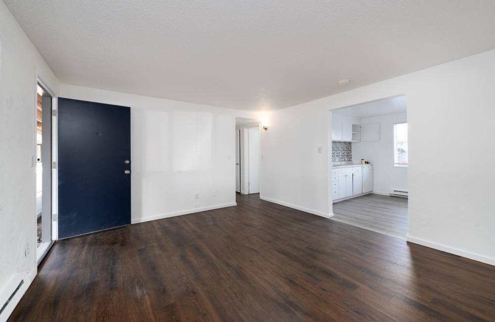 Apartment living room with wood style flooring at The Sage Collection in Tacoma, Washington