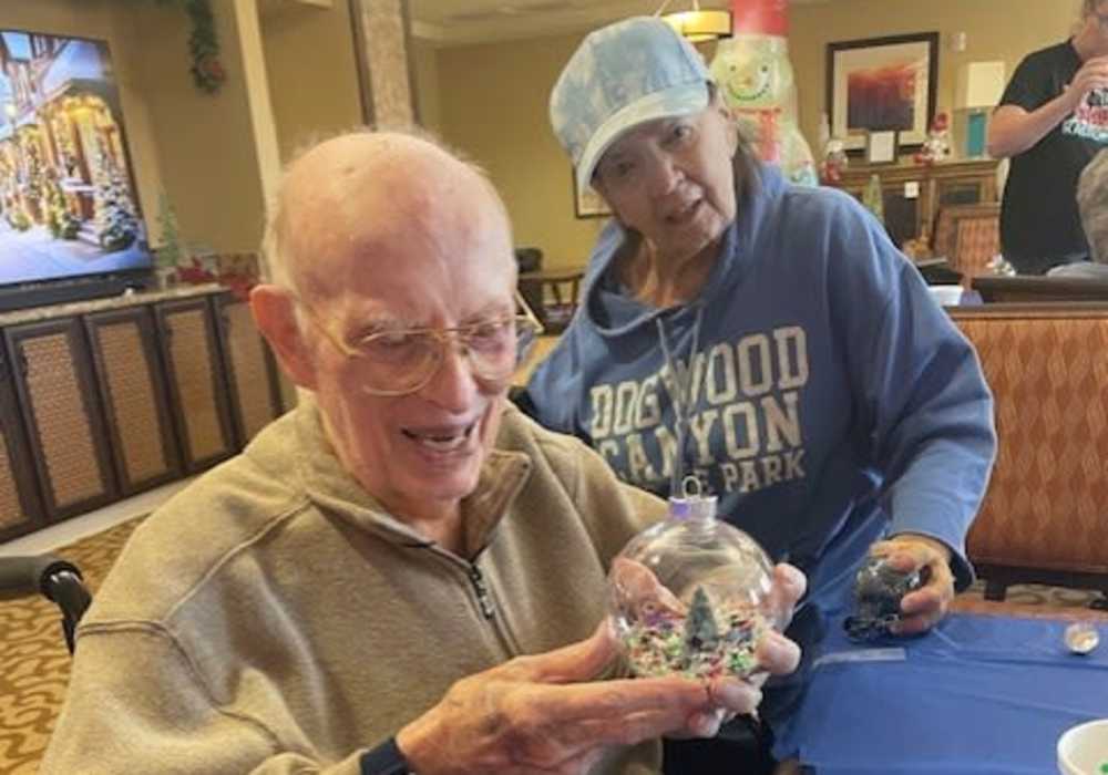 Residents with a snow globe at Truewood by Merrill, Keller in Keller, Texas