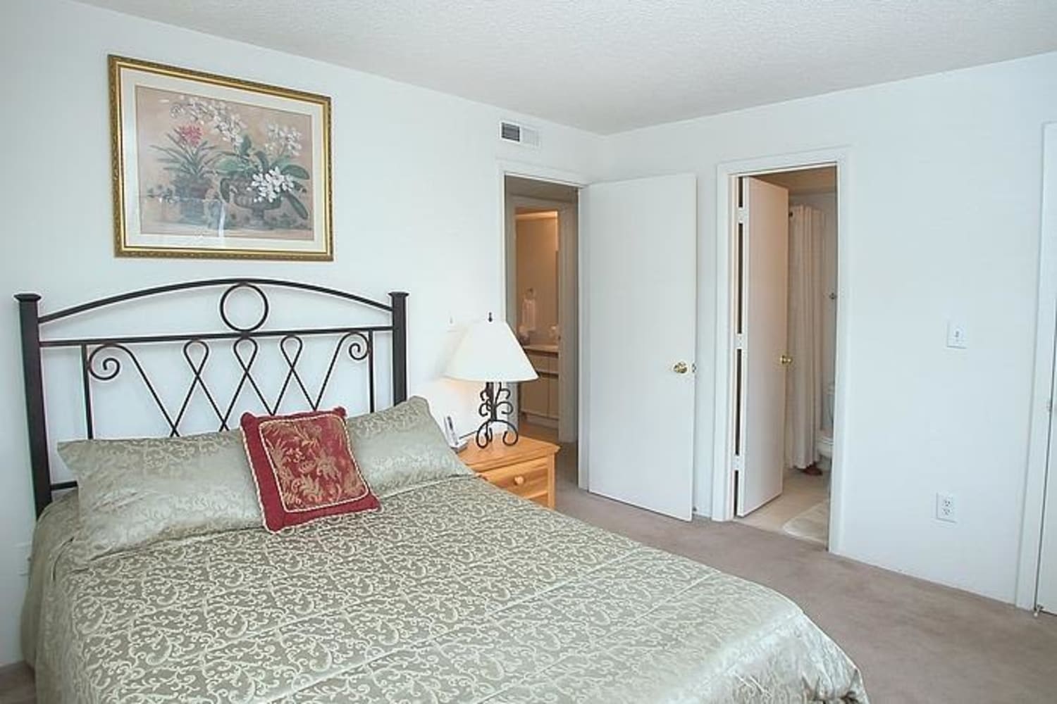 Model bedroom with a walk-in closet at Stonesthrow Apartment Homes in Greenville, South Carolina