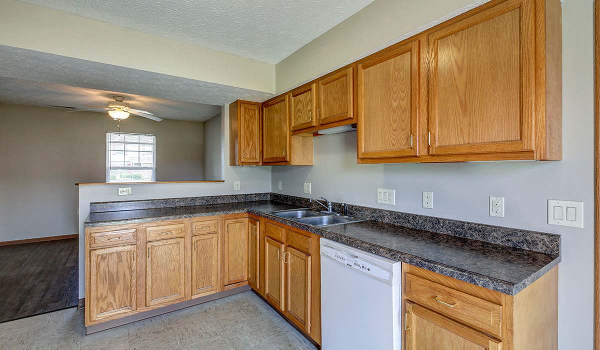 Wooden cabinets with a sink and countertop at Orchard Glen in Orrville, Ohio