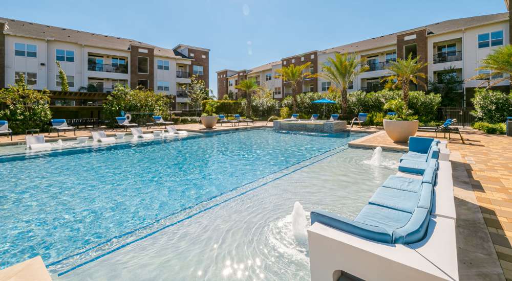Sparkling pool with lounge chairs at NOVU New Forest in Houston, Texas