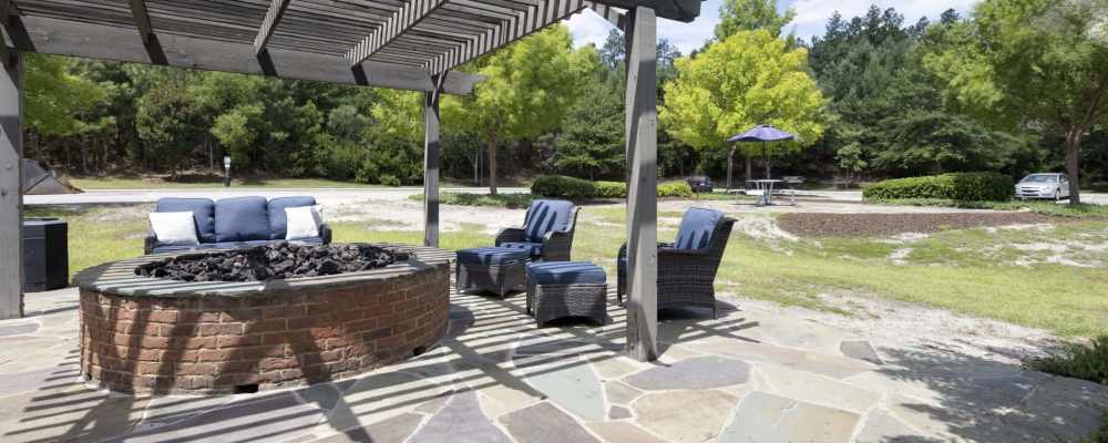 Exterior of a community apartment with fire pit at The Summits in Graniteville, South Carolina