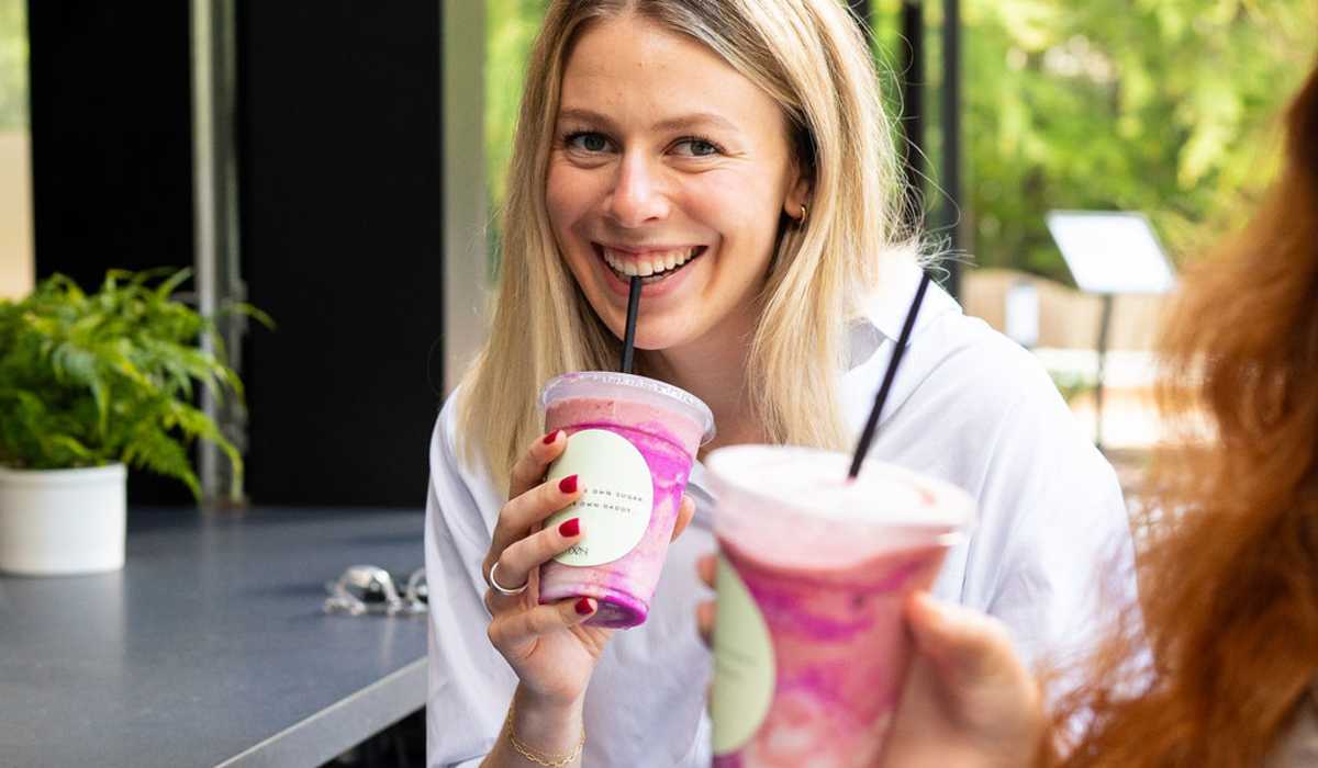 resident smiling while sipping a drink through a straw near Channel House in Raleigh, North Carolina