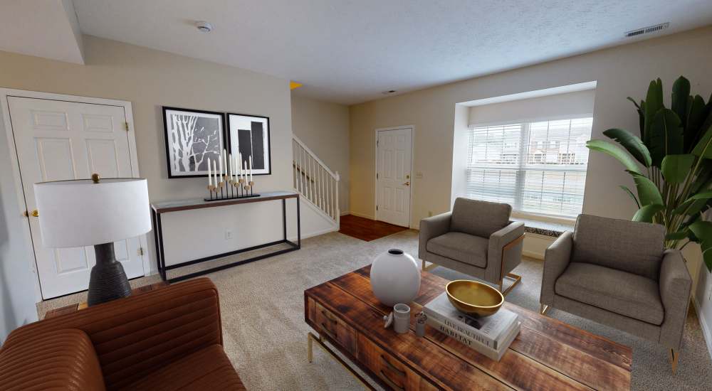 Cozy living room with modern furniture and natural light at Whispering Wind Apartments & Townhomes in Newtown, Ohio