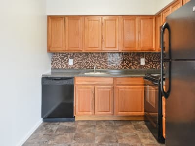 Maple cabinetry on display in the sleek kitchen at William Penn Village Apartment Homes in New Castle, DE