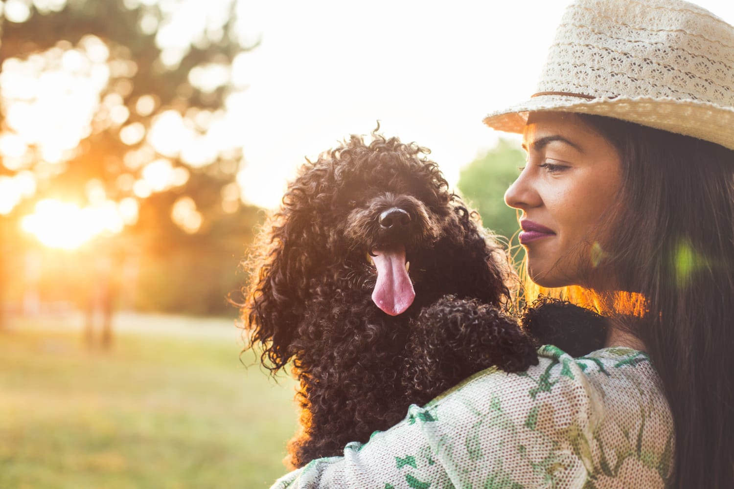 Resident couple plays with a dog in their new apartment at Lakeshore Apartment Homes in Evansville, Indiana