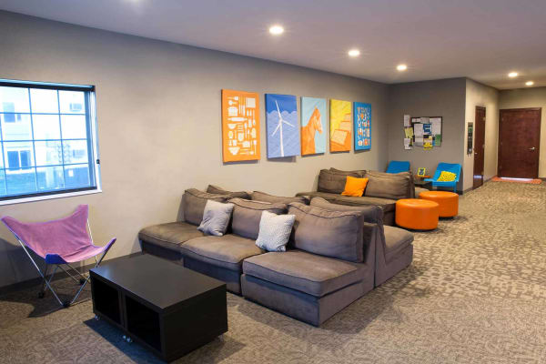 The clubhouse with seating and a TV at Campus View & Kirkwood Court in Cedar Rapids, Iowa