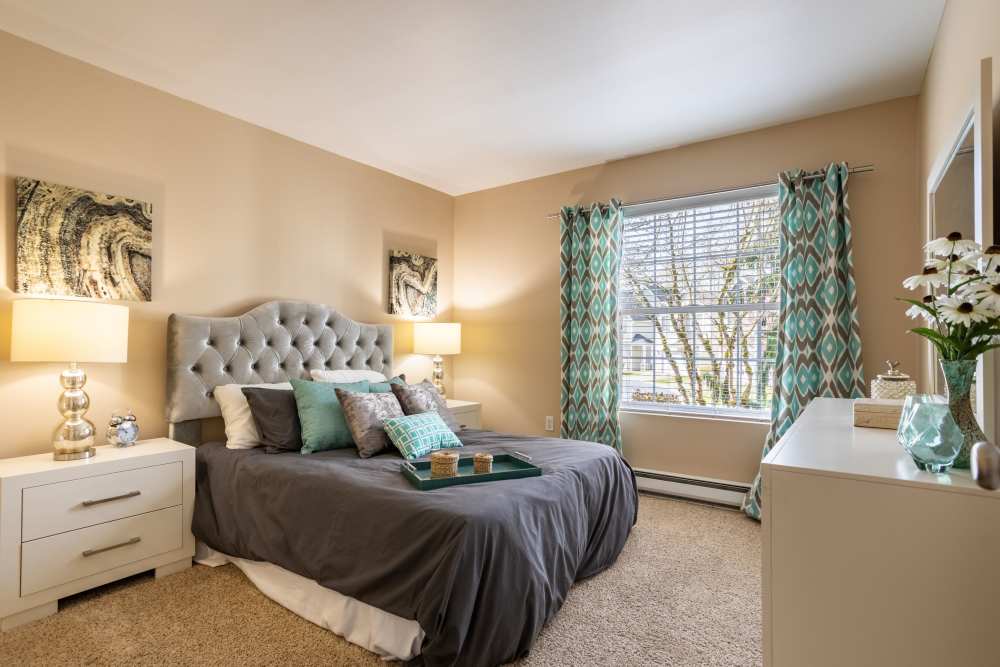 Spacious apartment bedroom with plush carpeting at Pebble Cove Apartments in Renton, Washington
