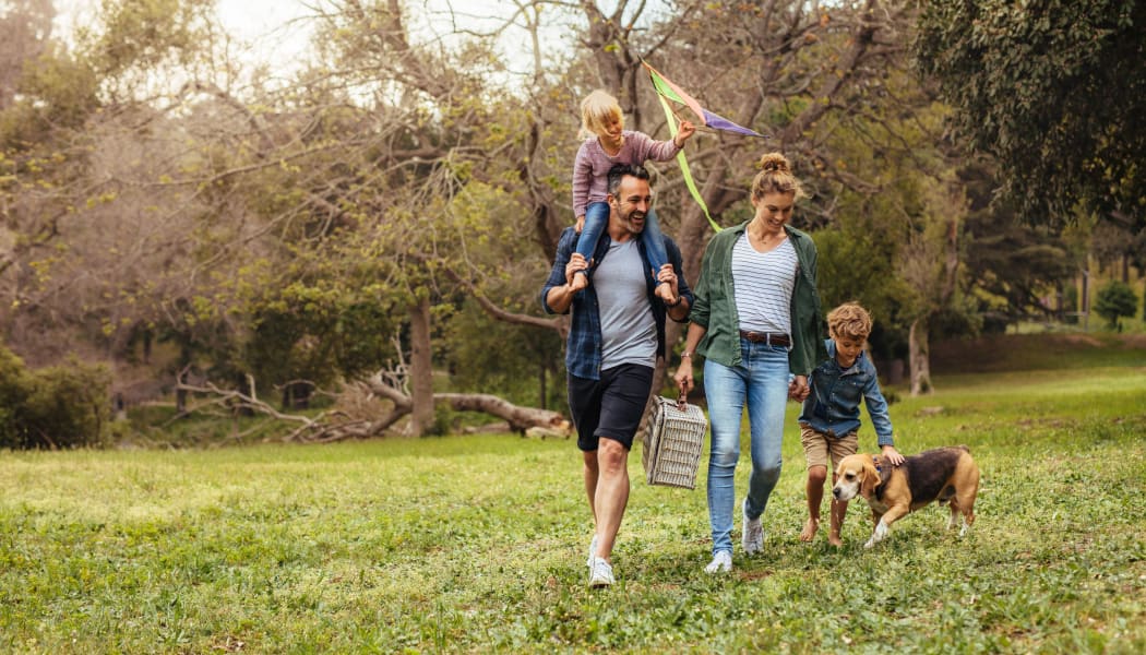 Family walking their dog at a park in Oklahoma City, Oklahoma near Stonehorse Crossing Apartments
