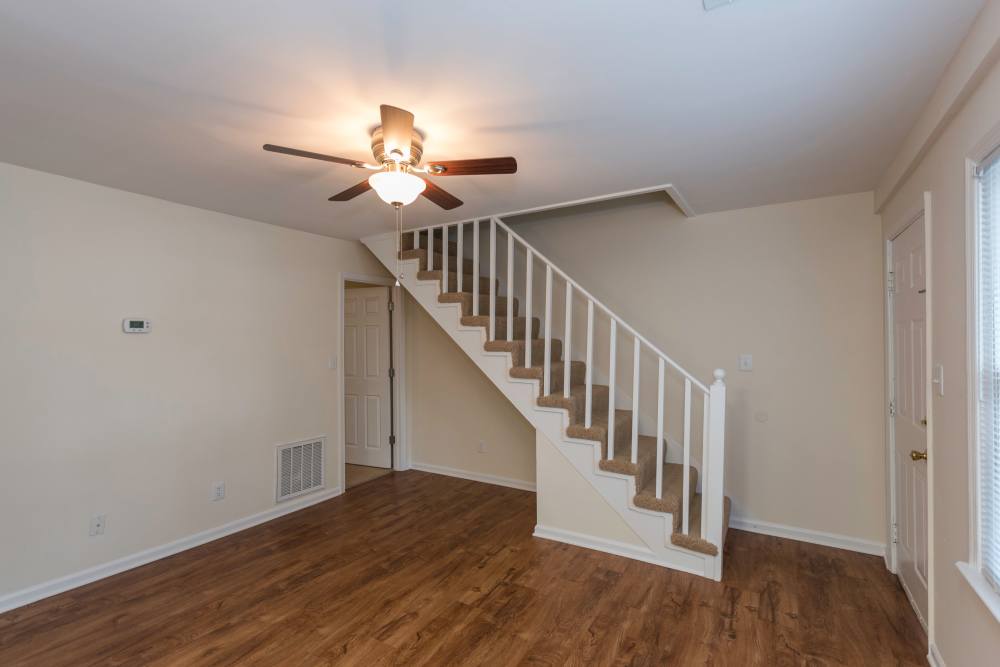 Spacious apartment with hardwood flooring and ceiling fans at Fox Chase Apartments in Fredericksburg, Virginia