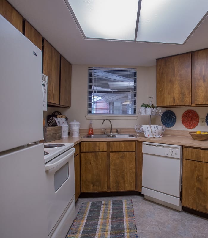 Kitchen with granite countertops at Woodscape Apartments in Oklahoma City, Oklahoma
