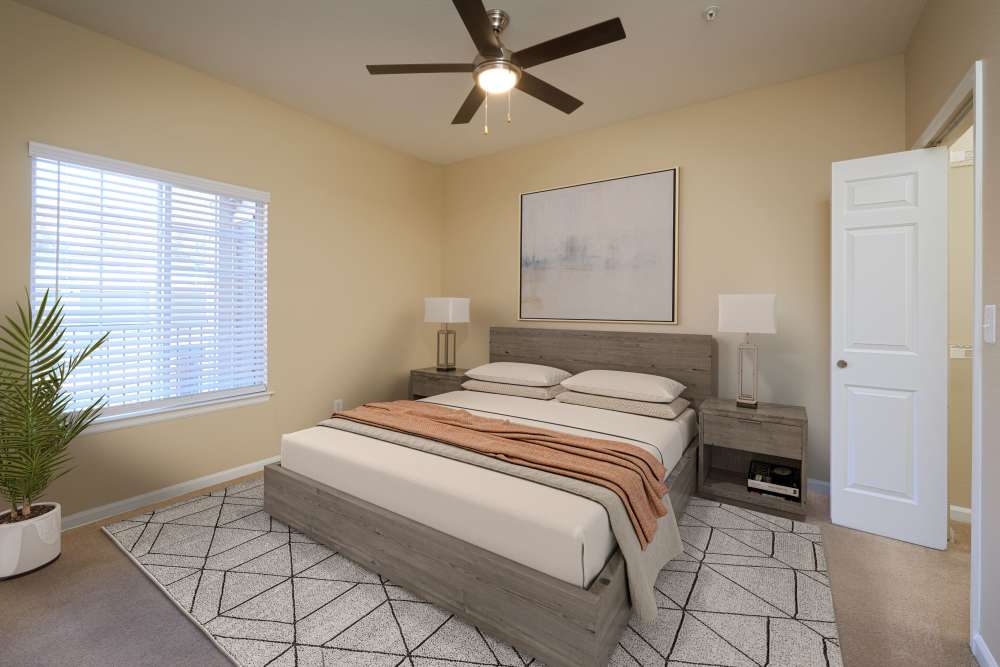 Bedroom with a large bed at Skyecrest Apartments in Lakewood, Colorado