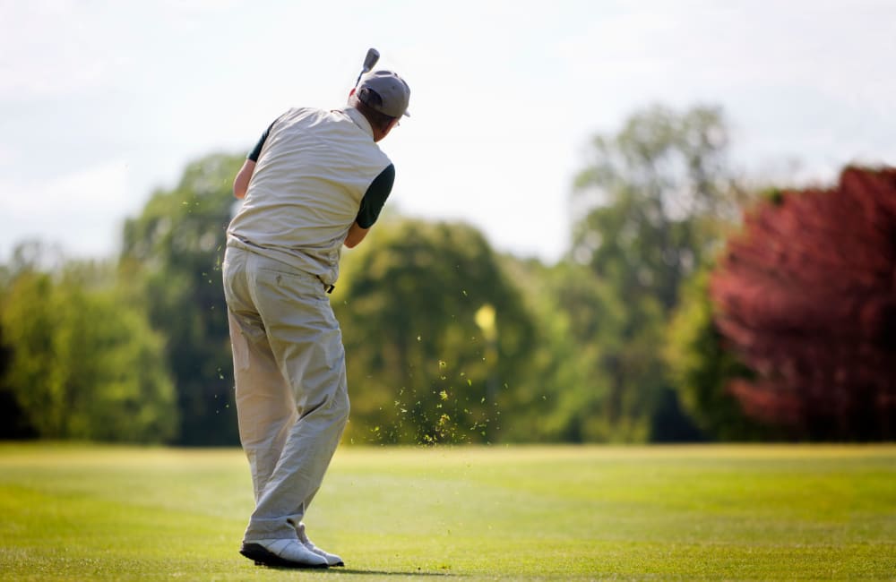 Resident playing golf at a golf course in Sacramento, California near Campus Commons Senior Living