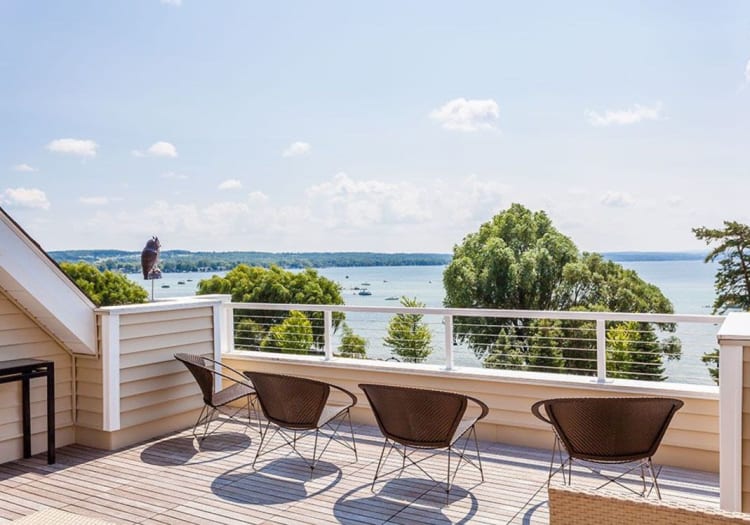 Outdoor lounge area overlooking the water on a beautiful day at Pinnacle North Apartments in Canandaigua, New York