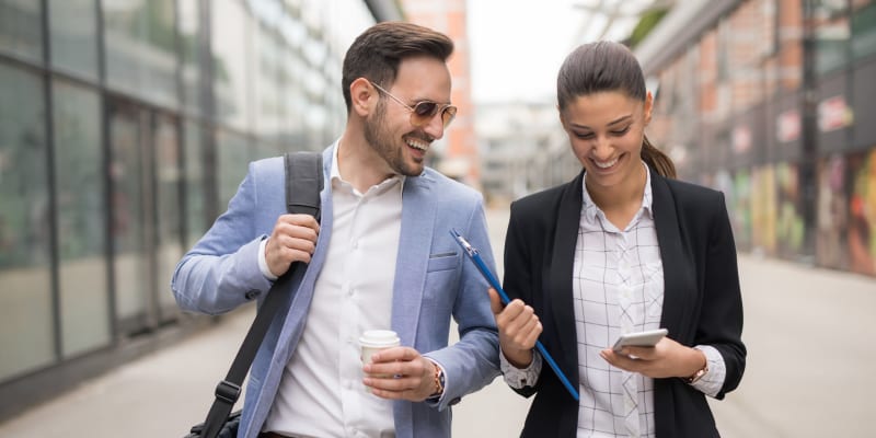 Coworkers chatting over coffee near Harbor Group Management in Norfolk, Virginia