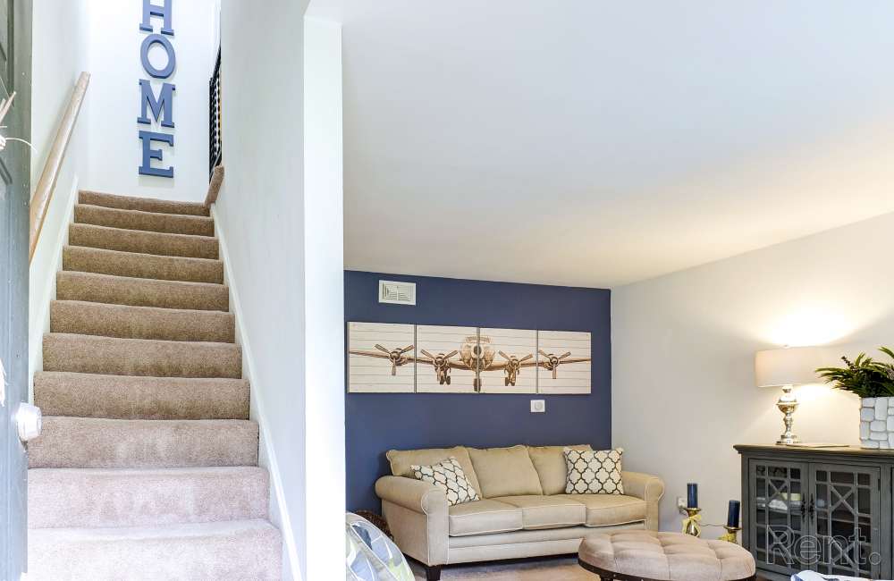 Cozy living room with plush sofa and stylish decor at Avian Place Apartments in North Charleston, South Carolina