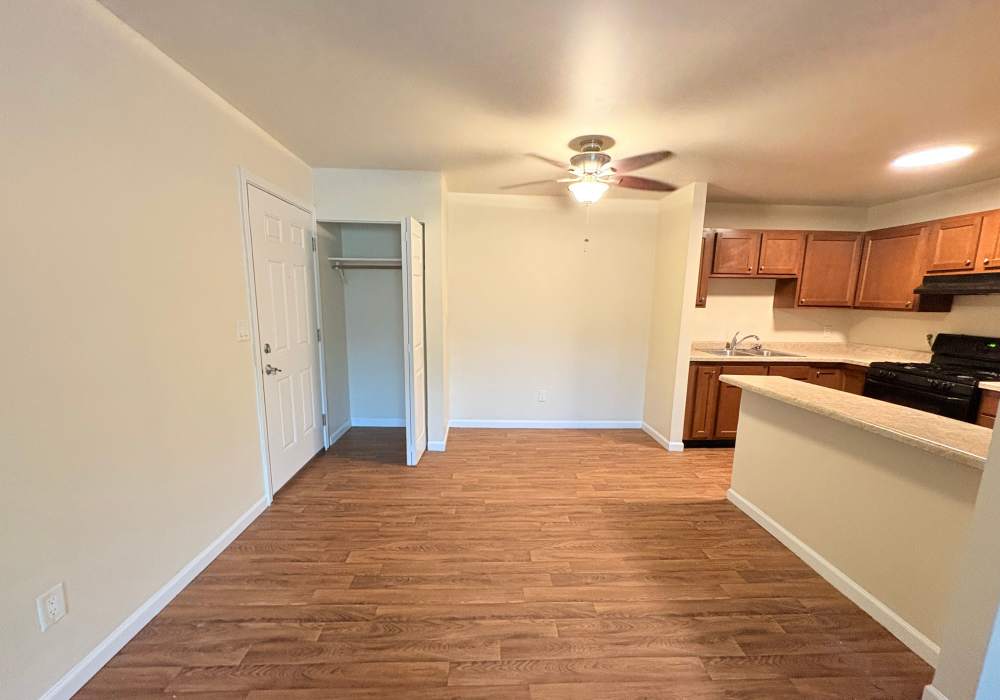 Dining area and kitchen with stainless steel appliances at Edgewood Group Apartments in Merrillville, Indiana