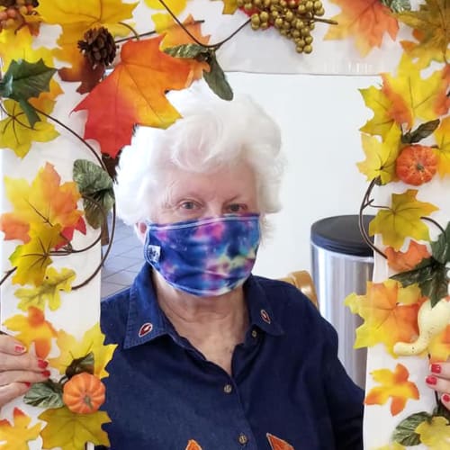 A resident holding up a floral frame at Ashbrook Village in Duncan, Oklahoma