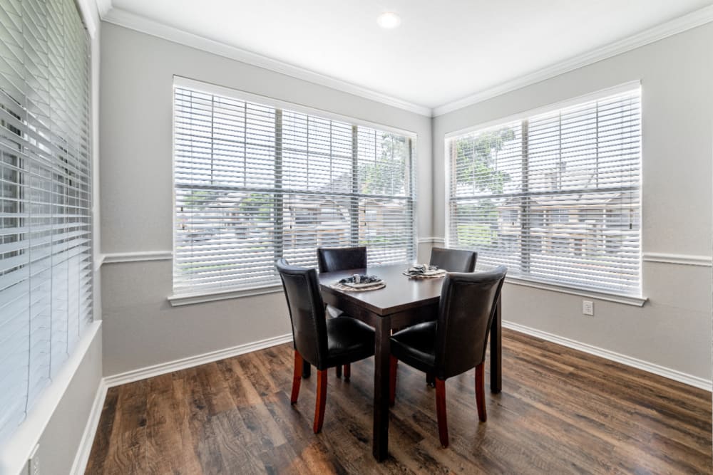 Bright dining room with large windows at Marquis at Bellaire Ranch in Fort Worth, Texas
