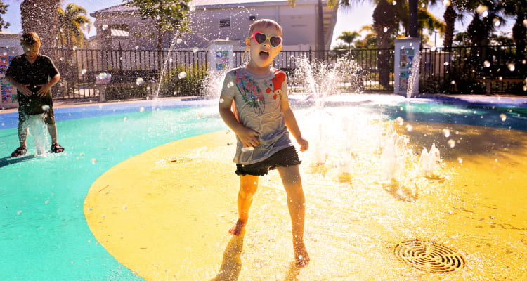 Children enjoying the splash pad at BB Living at Eastmark in Mesa, Arizona