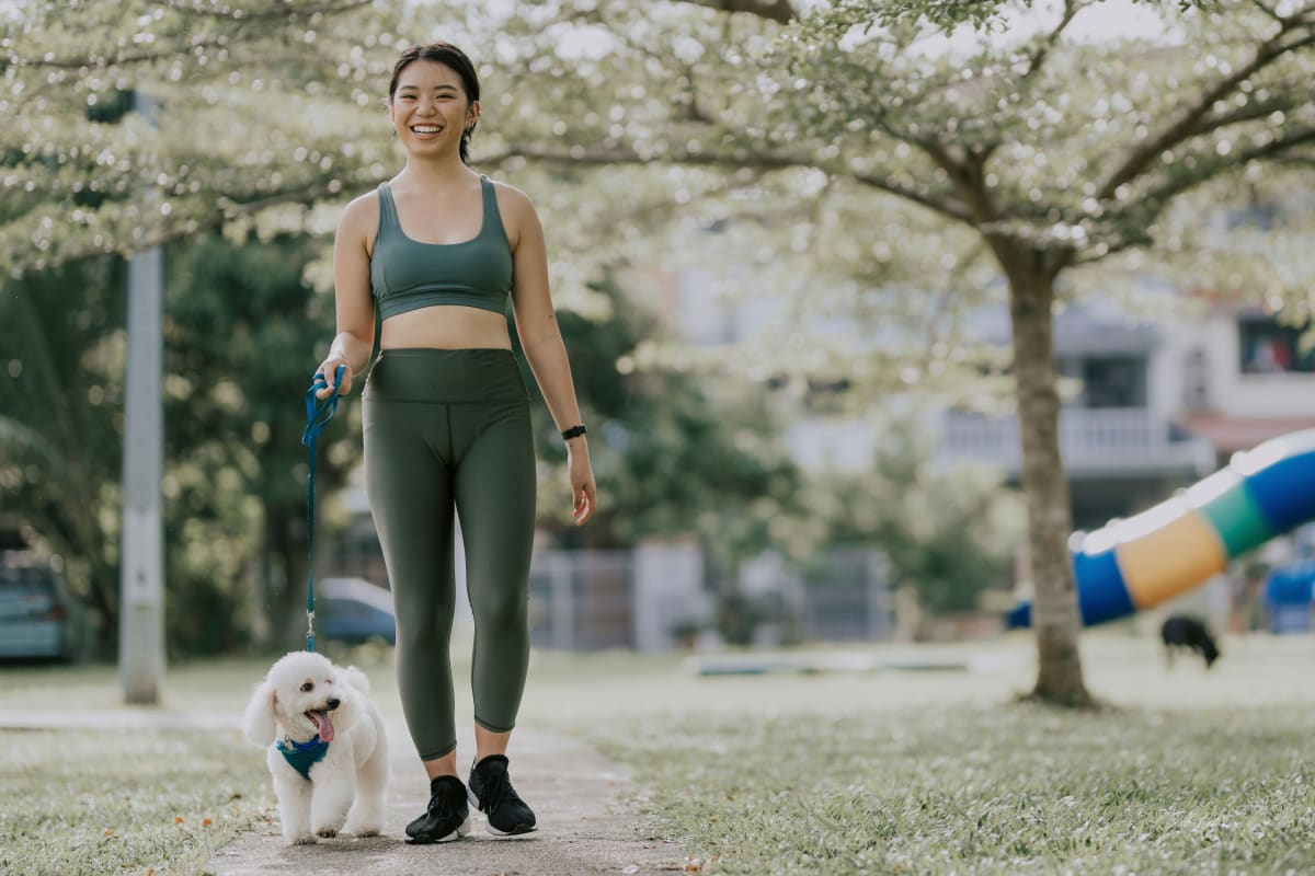 Resident and her pup walking to the onsite dog park at The Avery in Austin, Texas