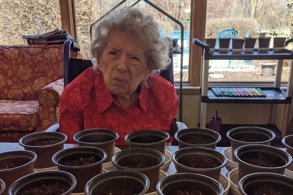 Resident working with flower pots at Ramsey Woods in Cudahy, Wisconsin.