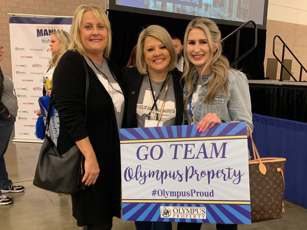 Employees posing for a photo at an event representing Olympus Property in Fort Worth, Texas