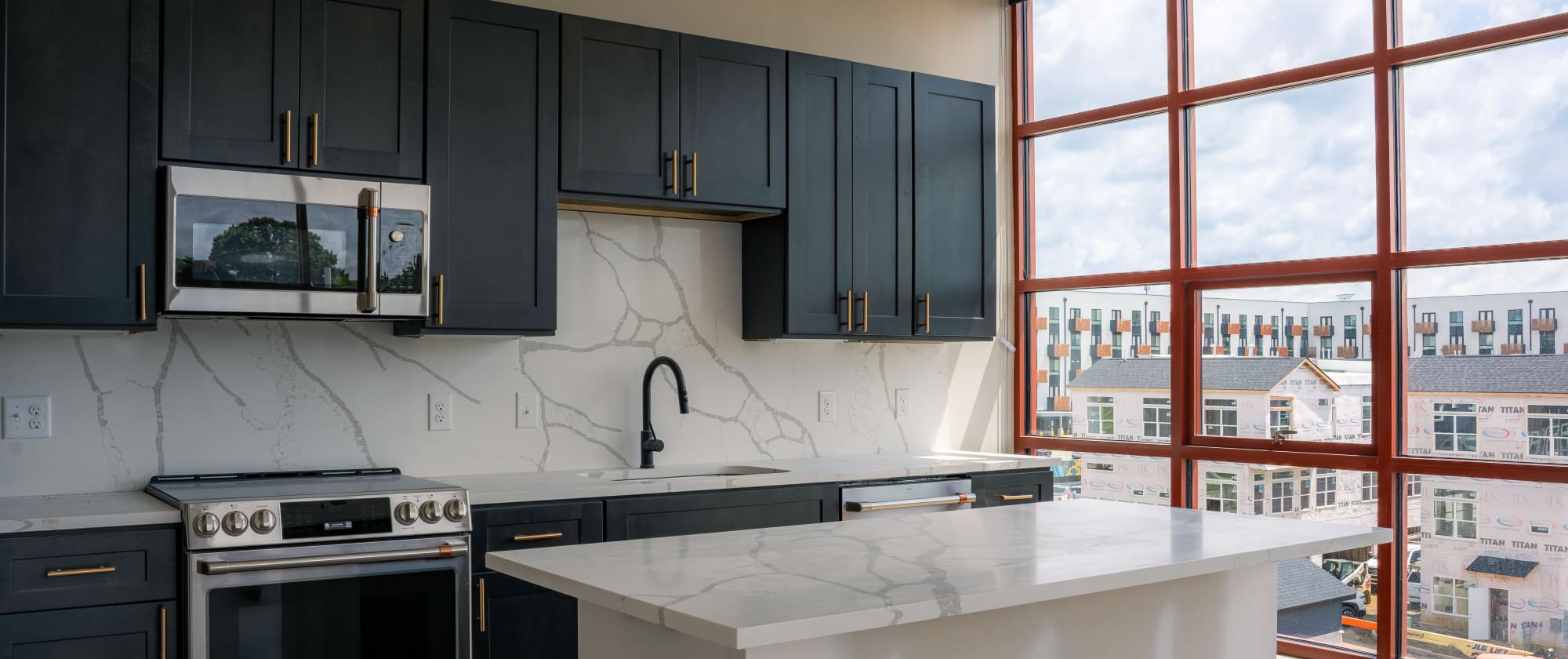 Luxury kitchen with granite countertops at Factory 52 Apartments & Townhomes in Norwood, OH