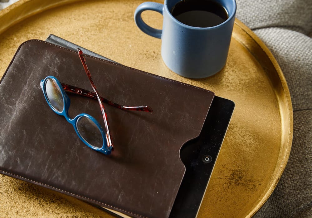 tablet and a cup of coffee sitting on a tray at a Amira Choice community