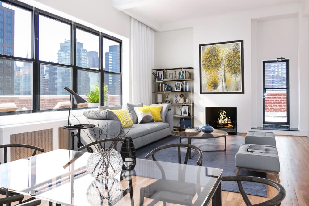 Spacious living room with a gigantic window for natural lighting at The Sutton Collection in New York, New York