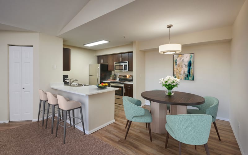 Renovated kitchen with brown cabinets at The Crossings at Bear Creek Apartments in Lakewood, Colorado