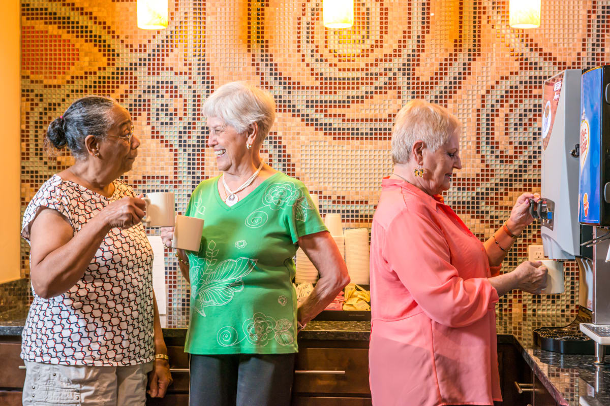 A few ladies hanging out by the coffee maker at Raider Ranch in Lubbock, Texas