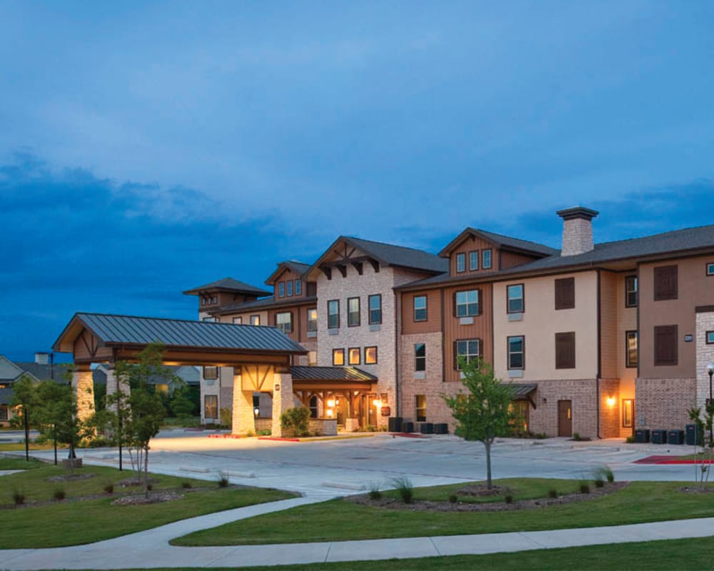 Exterior at Isle at Cedar Ridge in Cedar Park, Texas, with cozy seating and views of surrounding nature.