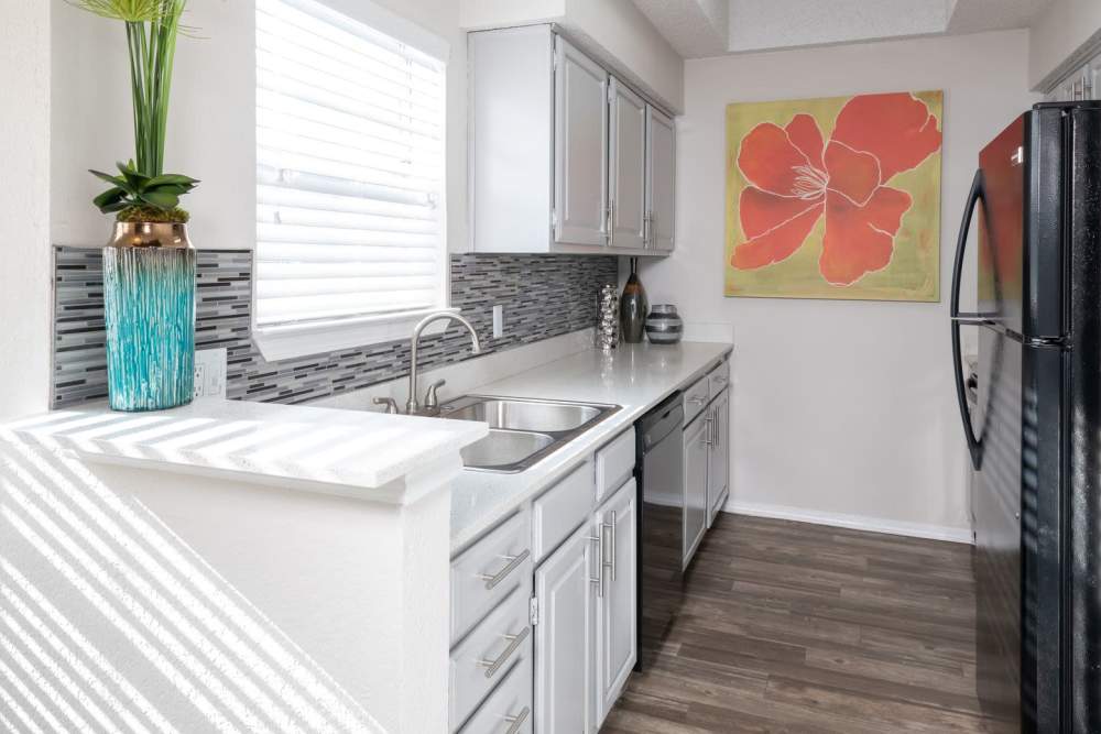 Apartment kitchen with quartz countertops at Copper Chase in Arlington, Texas