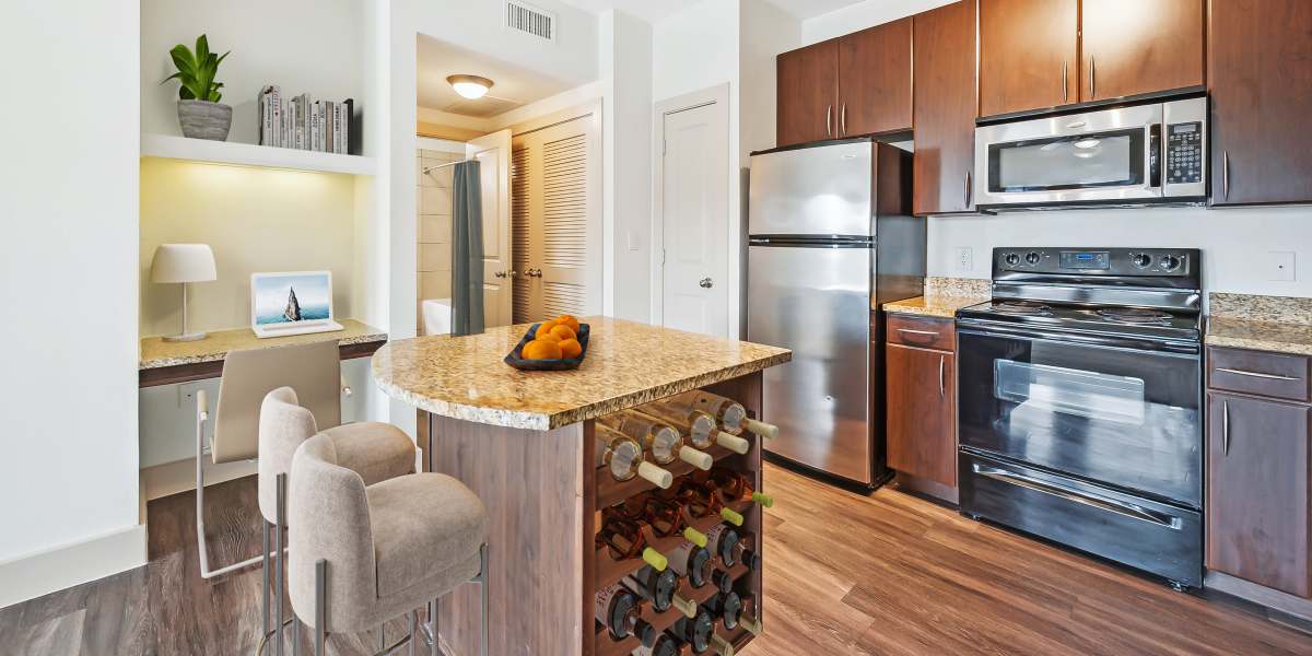 Modern kitchen with island and stools at Villas at Grand Avenue in Pflugerville, Texas