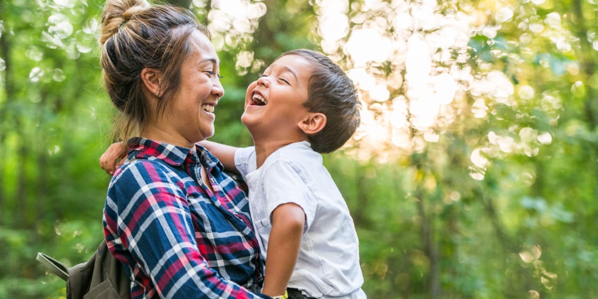 Resident holding and laughing with her son near The Fairmont at Willow Creek in Folsom, California