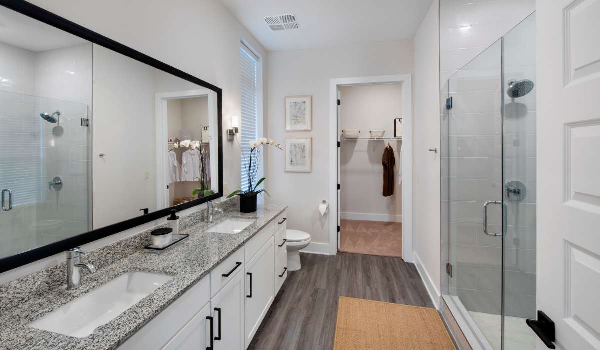 Bathroom with large mirror and vanity setup at The Row at Barrett, Kennesaw, Georgia